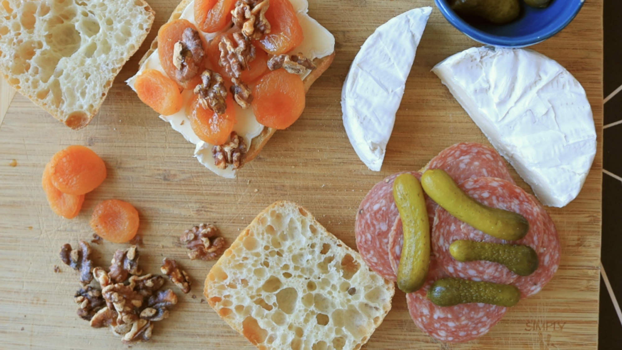 A cheeseboard sandwich on a cutting board.
